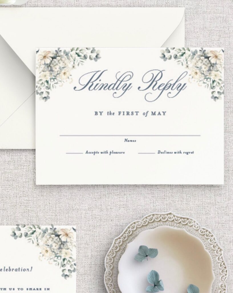 Wedding RSVP card with blue and green floral accents on beige fabric background