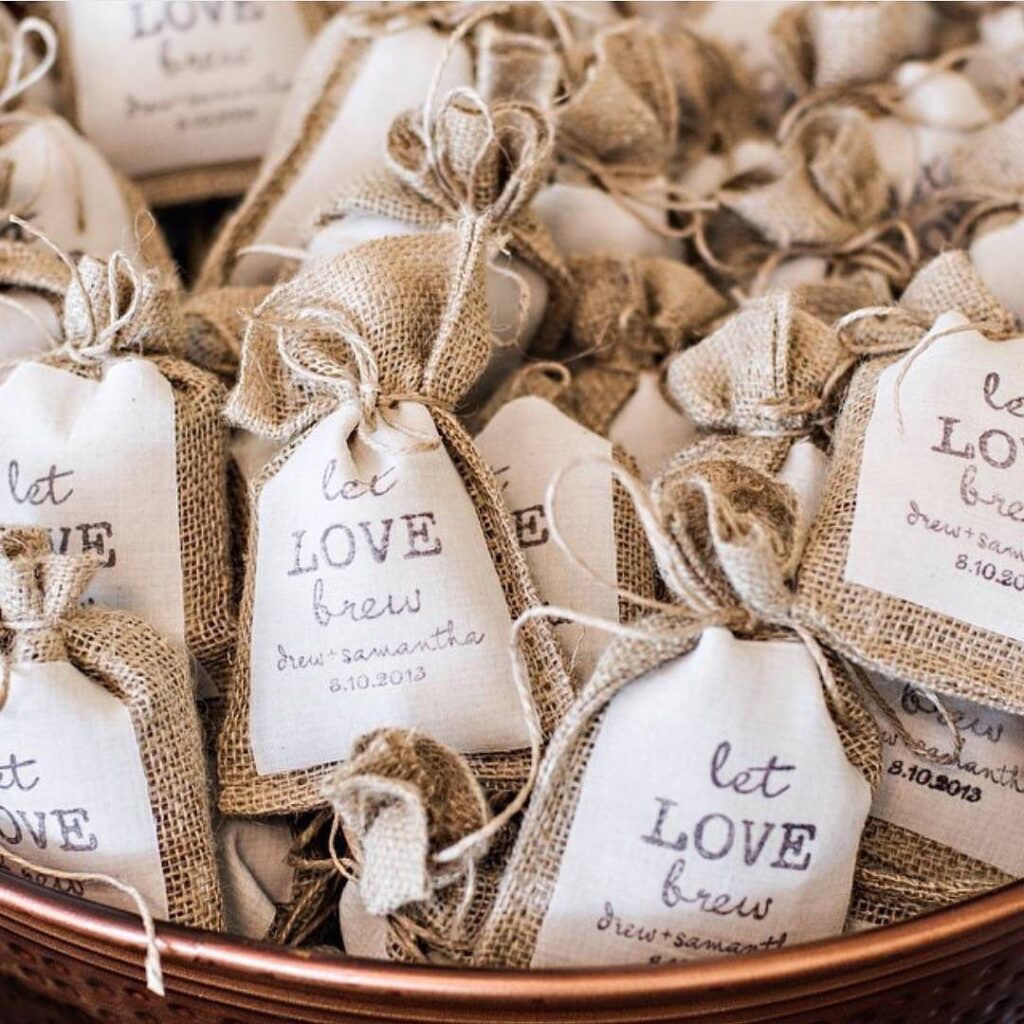Burlap coffee pouches with tags reading let love brew in a copper bowl